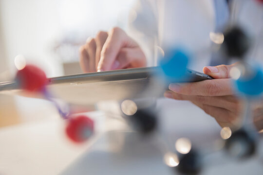 Mixed race scientist using digital tablet in laboratory