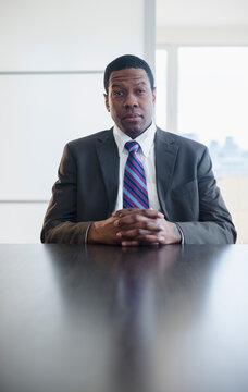 Businessman sitting at conference table in meeting