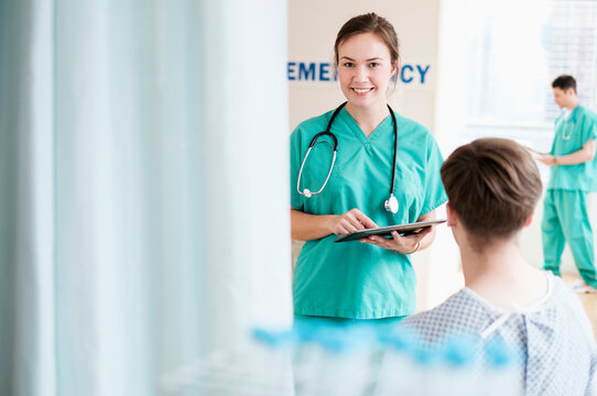 Doctor talking to patient in hospital emergency room