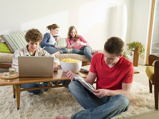 Caucasian friends relaxing in living room