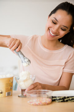 Chinese woman scooping ice cream