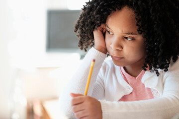 African American student writing in classroom