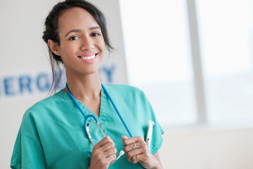 Mixed race nurse smiling in hospital