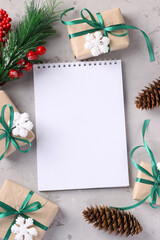 Christmas giftboxs with green ribbons on gray surface. Space for wishes. Holiday card. Top view.