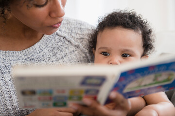 Mother reading book to baby son