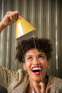 Glamorous Black woman holding party hat