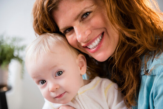 Smiling Caucasian mother holding baby son