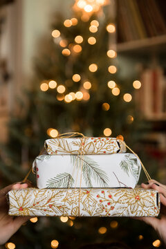Hands of Caucasian woman holding Christmas gifts