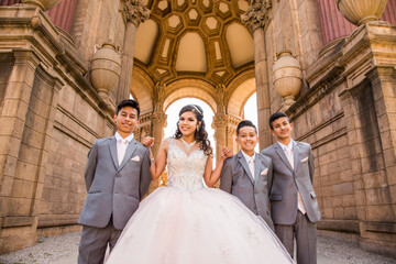 Hispanic girl posing with boys