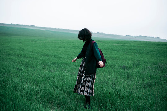 Caucasian woman standing in field of grass