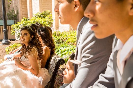 Hispanic boys and girls on bench