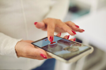 Hands of young female choosing boyfriend or possible husband in online dating application