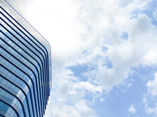modern glass facade of high rise building show contemporary architecture skyscraper reflect cloud...