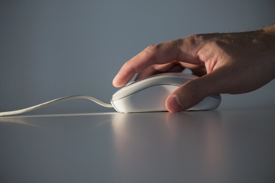 Studio shot of hand using computer mouse