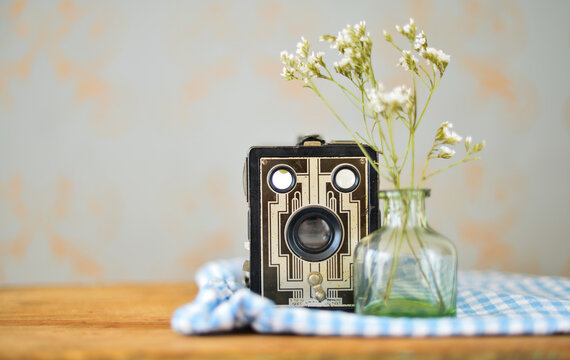 Studio shot of vintage camera and flowers