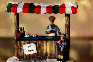 miniature scene of Christmas food stall with lights - traditional decoration figure