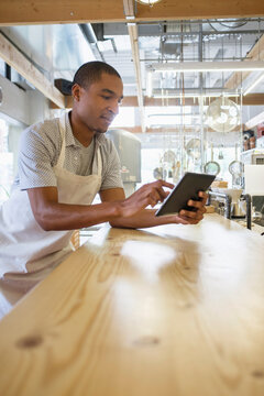 Bakery owner using digital tablet