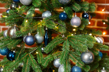 Beautiful Christmas tree decorated with blue and silver toys. New Years is soon. Decorations for Christmas Day