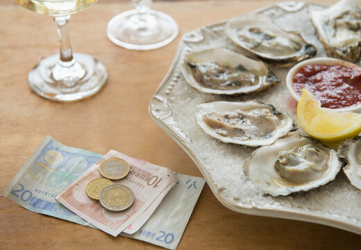 Studio shot of oysters and money