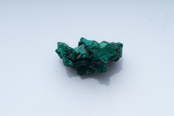 Malachite green ore on a white background. Natural green malachite