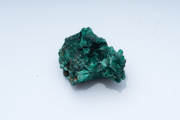 Malachite green ore on a white background. Natural green malachite