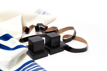 Еallith and tefillin on white background. Close up