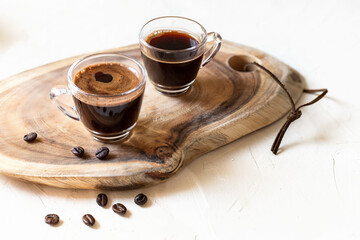 Two cups of coffee espresso,   on wooden background. 