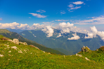 Naklejka premium Beautiful mountain landscape at Caucasus mountains with clouds and blue sky