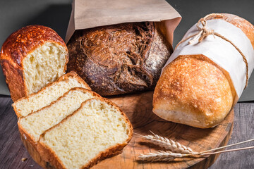 Various rustic bread on a wooden board. Healthy food and farming concept