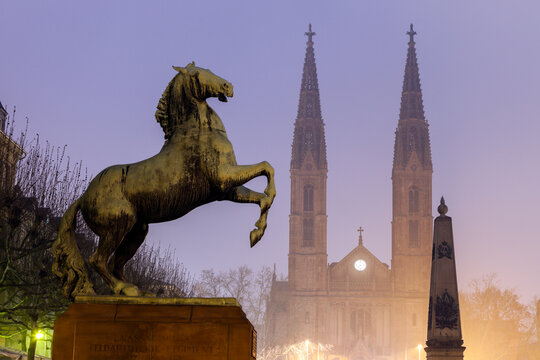 Horse sculpture of Waterloo Memorial and St. Boniface Church in mist