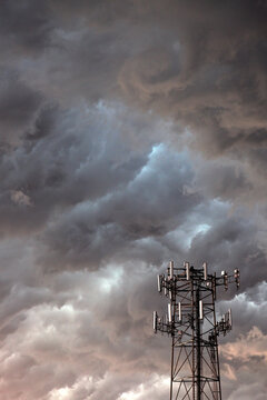Telecommunication antenna in front of storm clouds