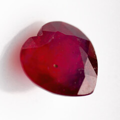 Natural ruby in the shape of a heart on a white background