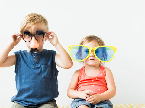 Children (2-3) wearing novelty glasses