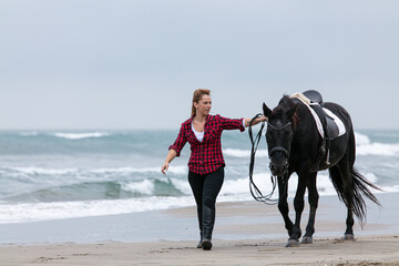 young woman on a horse on the beach