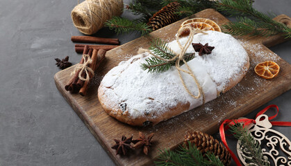 Christmas tasty stollen with dry fruits, berries and nuts on wooden board. Traditional German treats.