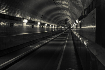 bicycle driver with light rides through historic old tunnel under the river elbe in hamburg