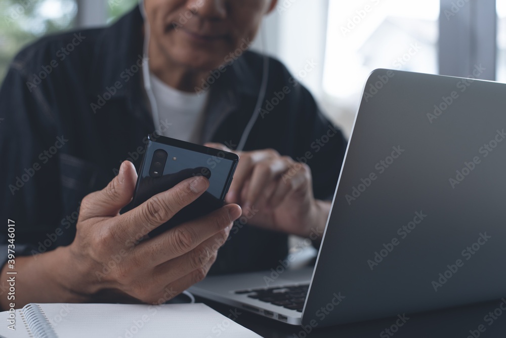 Aufkleber casual business man making video call using online meeting app via mobile phone and working on lapto