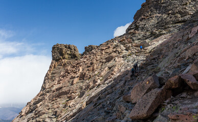Fototapeta na wymiar Wide shot of climbers climb in part of trail to top of Longs peak in rocky mountains national park in america