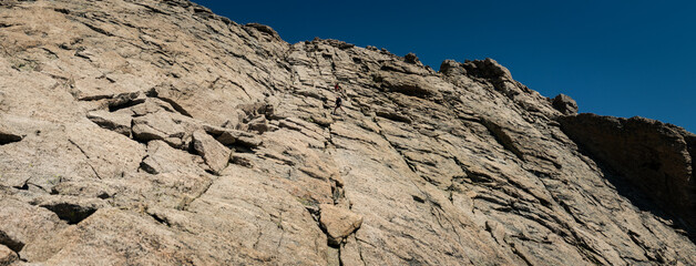 Wide shot  of climbers climb part of trail to top of Longs peak in rocky mountains national park in america