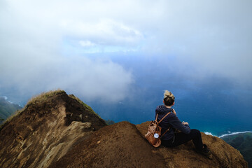 a man sitting on a rock