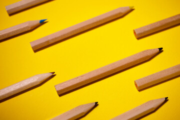 The pattern of colored pencils on a yellow background. There is a space for text.