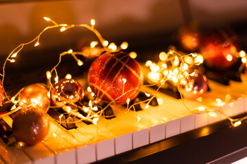 Festive decor on piano keys indoors, closeup. Christmas music