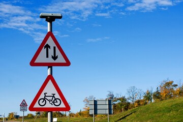 UK Triangle Road Warning signs, Two-way traffic straight ahead, with Cycle route ahead.for cycles...