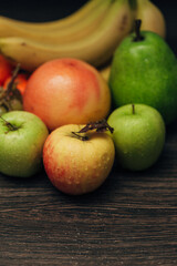 Composition with Summer Colorful Fresh Fruits on Wooden Brown Background
