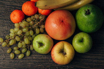 Composition with Summer Colorful Fresh Fruits on Wooden Brown Background