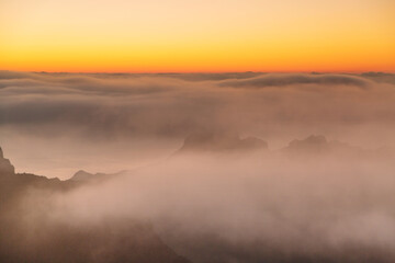sunset over the mountains in the clouds