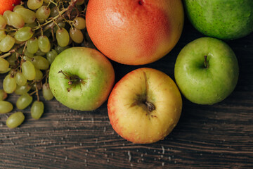 Composition with Summer Colorful Fresh Fruits on Wooden Brown Background
