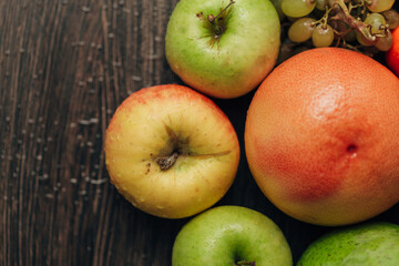 Composition with Summer Colorful Fresh Fruits on Wooden Brown Background