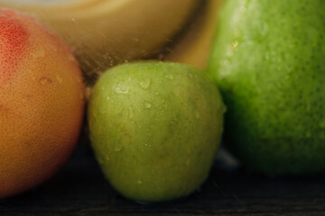 Composition of Summer Colorful Fresh Fruits with Water Droplets on the Peel