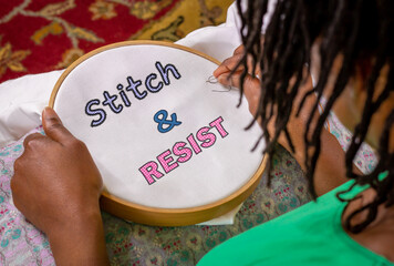 craft activism, woman sewing Stitch and Resist embroidery on hoop, craftivism ethnic feminist...